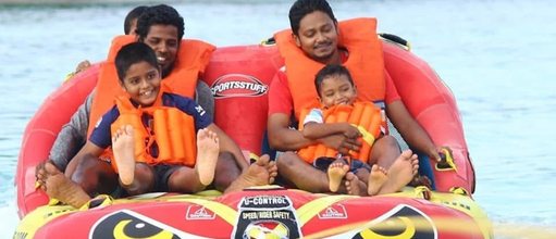 Families riding a funtube in Vaikaradhoo